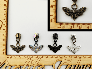 Double-sided Death Moth Zipper Pulls. Available in 4 finishes